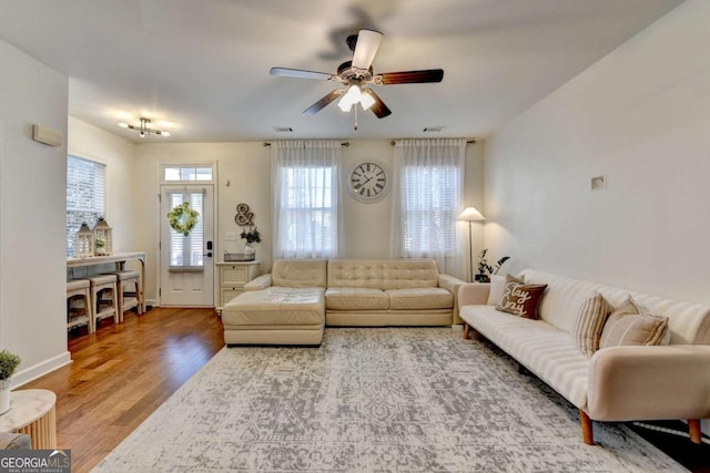 living room featuring hardwood / wood-style flooring and ceiling fan