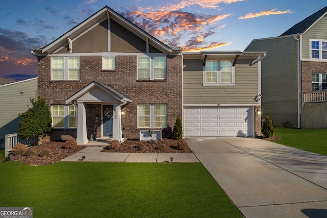 view of front facade featuring a garage, a yard, concrete driveway, and brick siding