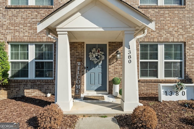 property entrance featuring brick siding