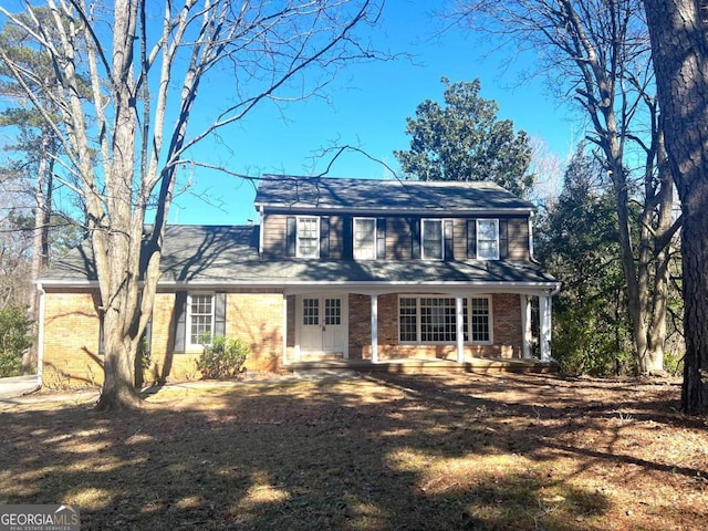 colonial inspired home with a front lawn