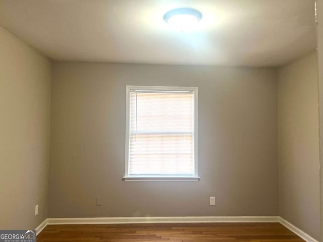 unfurnished room featuring hardwood / wood-style floors