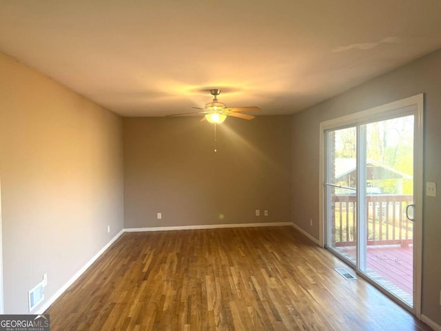 spare room with ceiling fan and wood-type flooring