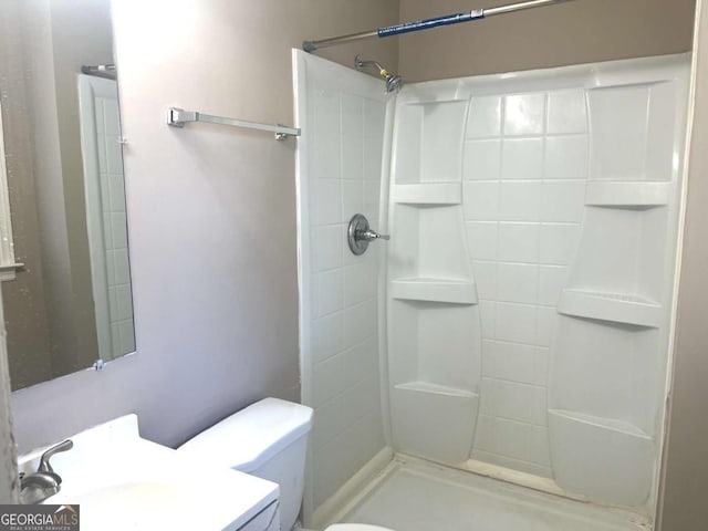 bathroom with toilet and walk in shower