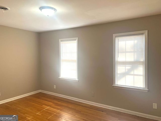 spare room with wood-type flooring