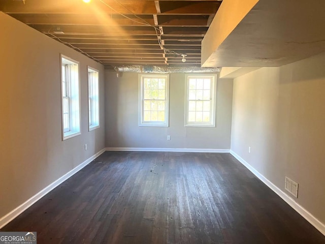 spare room featuring dark wood-type flooring