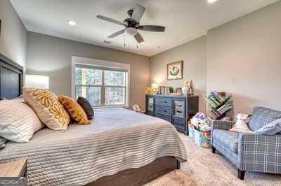 bedroom with ceiling fan and carpet