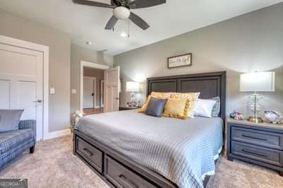 bedroom featuring ceiling fan and light carpet