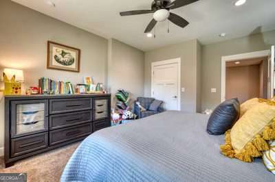 carpeted bedroom with ceiling fan