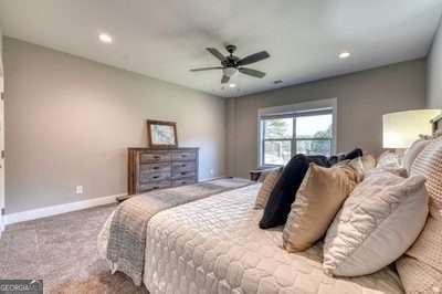 carpeted bedroom featuring ceiling fan