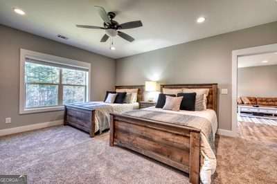 bedroom featuring ceiling fan and light colored carpet