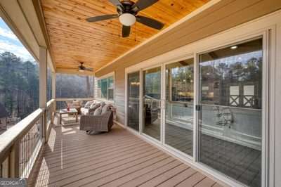 wooden deck featuring ceiling fan