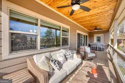 wooden deck featuring an outdoor living space and ceiling fan