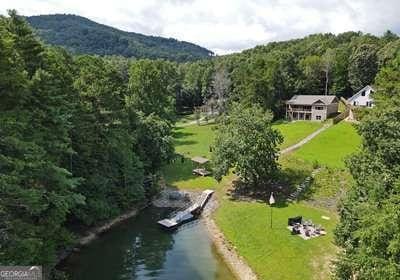 drone / aerial view featuring a water and mountain view