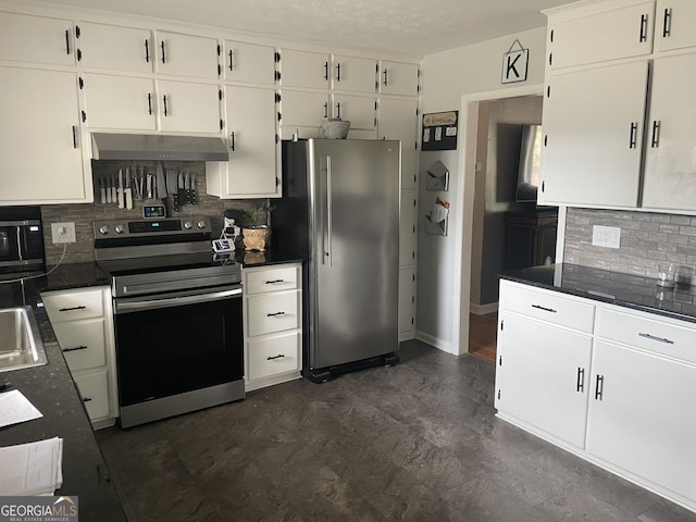 kitchen with appliances with stainless steel finishes, dark countertops, white cabinets, and under cabinet range hood