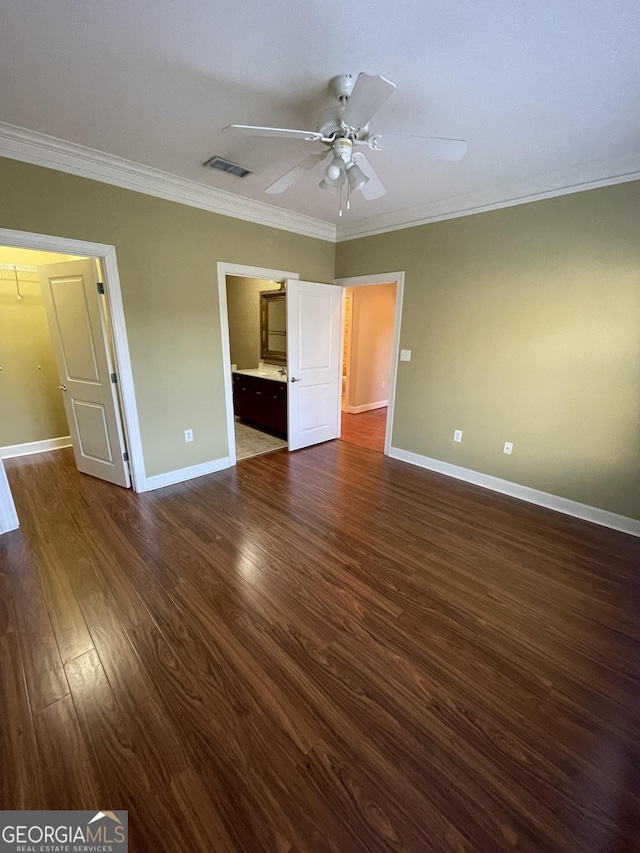 unfurnished bedroom with ceiling fan, ornamental molding, and dark wood-type flooring