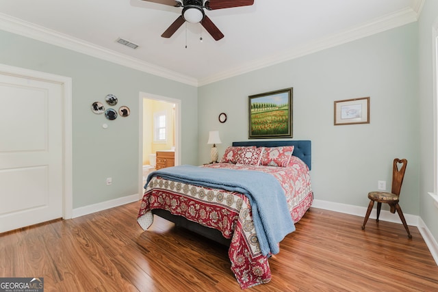 bedroom featuring ensuite bathroom, ceiling fan, hardwood / wood-style flooring, and crown molding