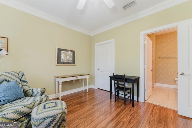 living area featuring ornamental molding, hardwood / wood-style floors, and ceiling fan