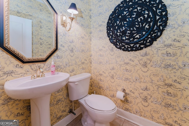 bathroom with toilet and tile patterned flooring