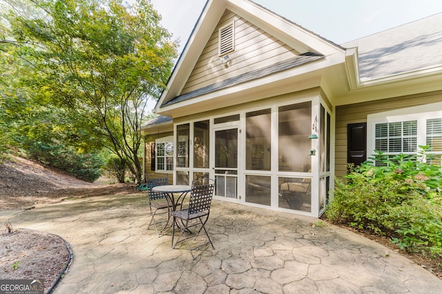 exterior space with a patio and a sunroom