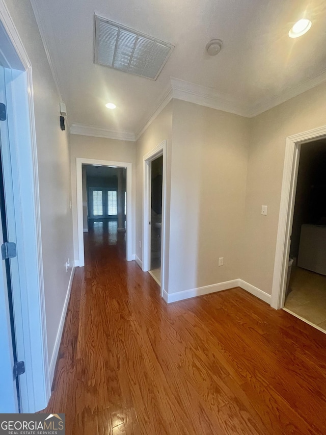 hallway with crown molding and hardwood / wood-style floors