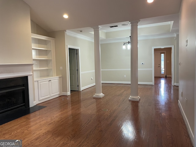 unfurnished living room featuring dark wood-type flooring, ornate columns, and crown molding