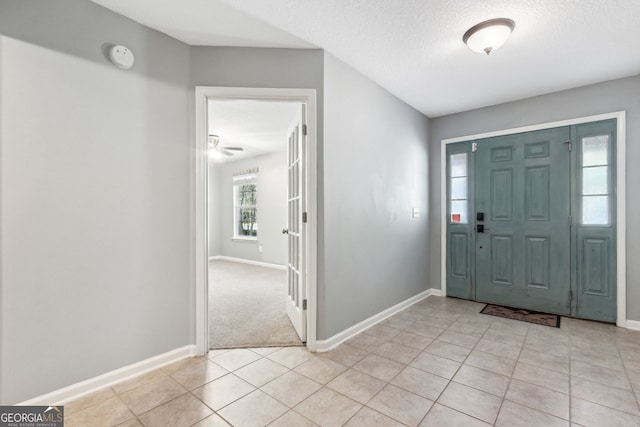 tiled foyer featuring a textured ceiling