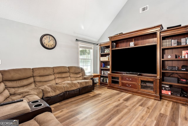 living room featuring hardwood / wood-style flooring and lofted ceiling