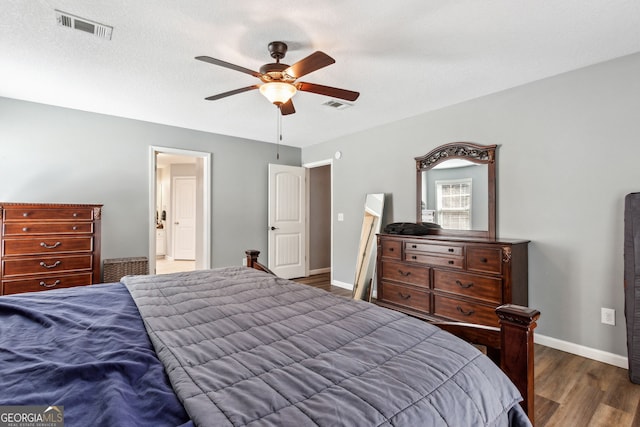 bedroom featuring ceiling fan, dark wood-type flooring, and a textured ceiling