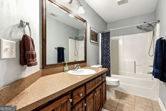 full bathroom featuring vanity, a textured ceiling, toilet, tile patterned floors, and shower / tub combo with curtain