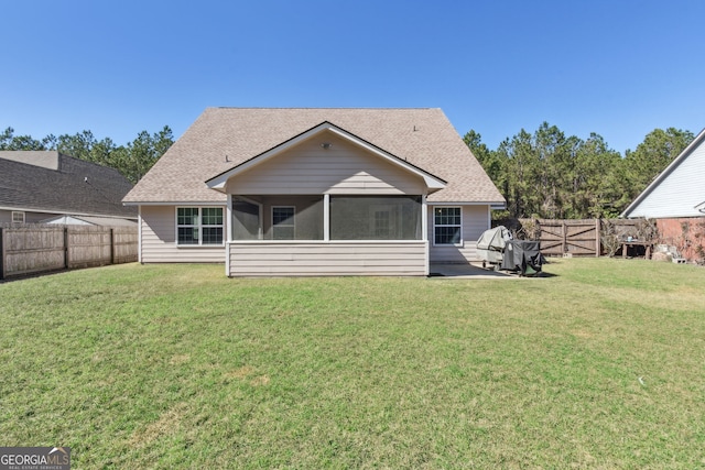 back of house with a yard, a patio area, and a sunroom