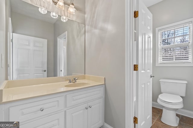 bathroom featuring toilet and vanity