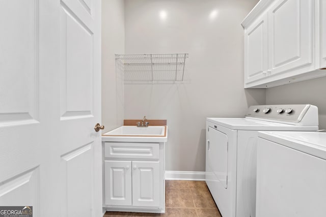 clothes washing area with washing machine and dryer, cabinets, sink, and light tile patterned floors