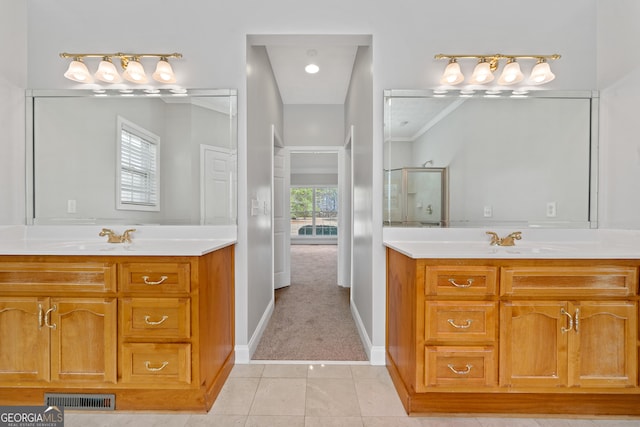 bathroom with vanity, tile patterned flooring, an enclosed shower, and a wealth of natural light