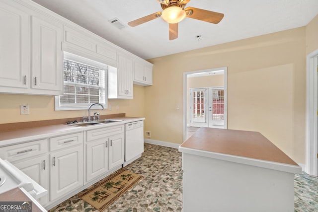 kitchen featuring french doors, sink, white dishwasher, ceiling fan, and white cabinets