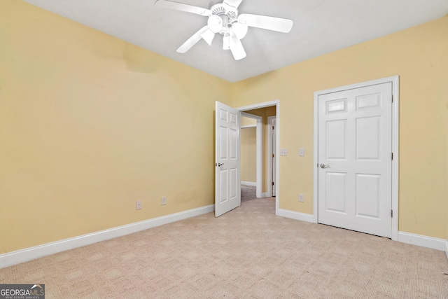 unfurnished bedroom with light carpet and ceiling fan