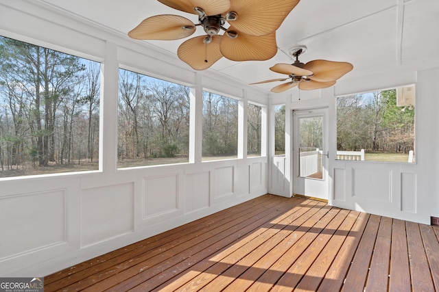 unfurnished sunroom featuring ceiling fan