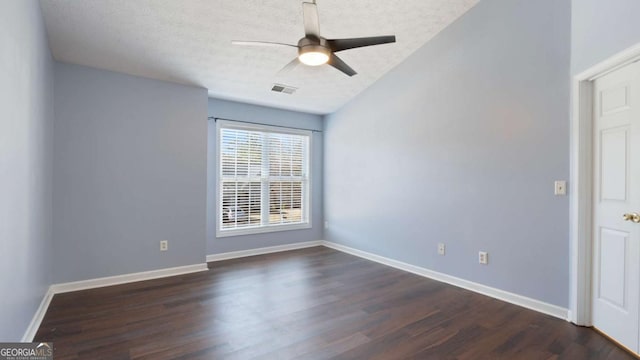 spare room with baseboards, visible vents, dark wood-style flooring, ceiling fan, and a textured ceiling