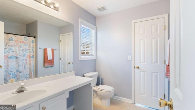 bathroom featuring vanity, toilet, baseboards, and visible vents