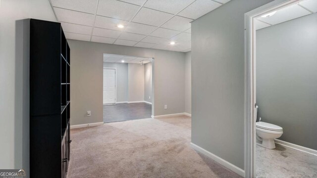 interior space featuring a drop ceiling, recessed lighting, and baseboards