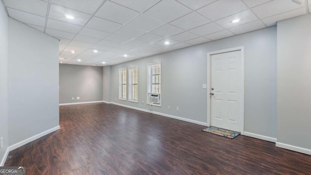 unfurnished room featuring recessed lighting, wood finished floors, baseboards, and a drop ceiling