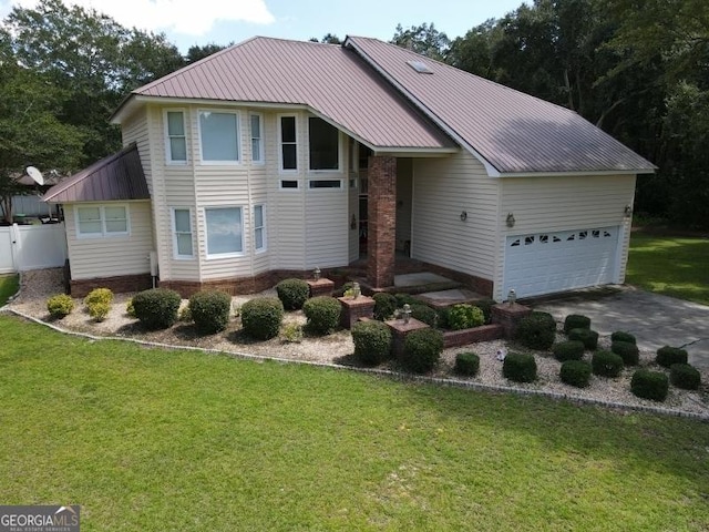 view of front of home with driveway, metal roof, a garage, and a front lawn