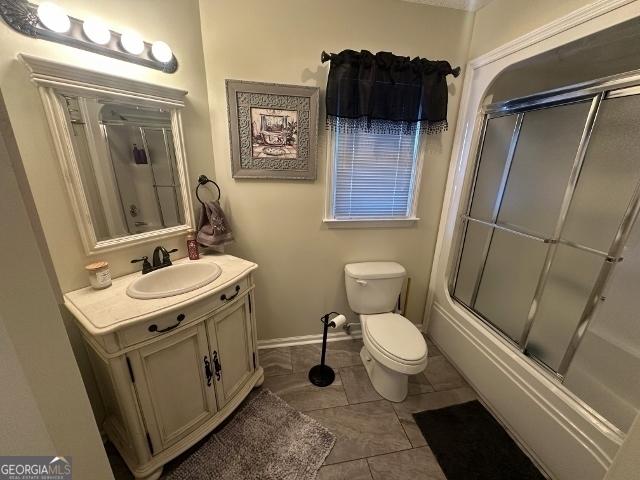 11 Plantation Dr, Swainsboro, GA 30401 - full bath with enclosed tub / shower combo, tile patterned flooring, toilet, vanity, and baseboards