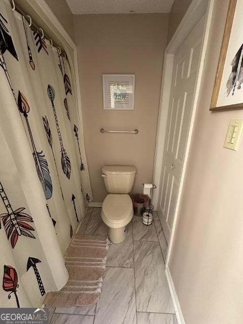 11 Plantation Dr, Swainsboro, GA 30401 - full bathroom featuring toilet, marble finish floor, and baseboards