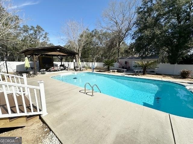 11 Plantation Dr, Swainsboro, GA 30401 - view of pool featuring a gazebo, a patio area, a fenced backyard, and a fenced in pool