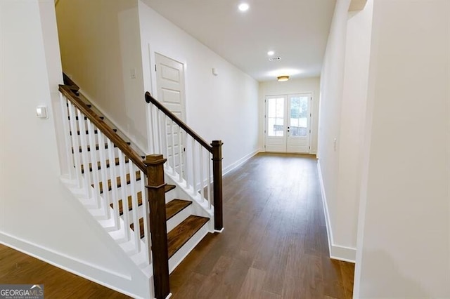 staircase featuring hardwood / wood-style floors and french doors