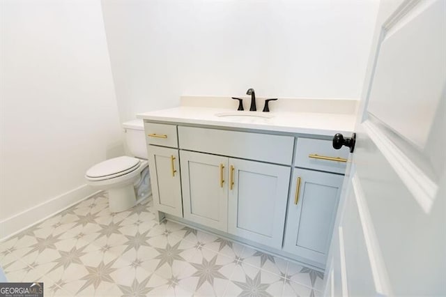 bathroom featuring toilet and vanity