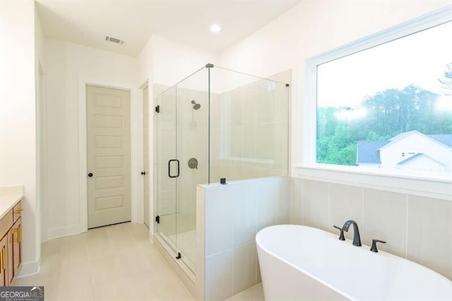 bathroom with separate shower and tub and vanity