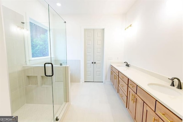 bathroom featuring vanity and a shower with door