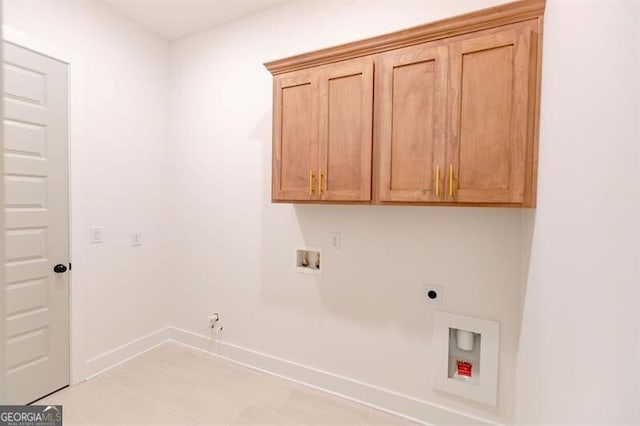 laundry room featuring hookup for a washing machine, gas dryer hookup, cabinets, and hookup for an electric dryer