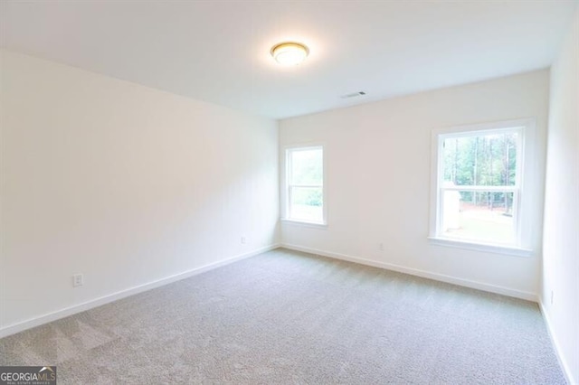 empty room featuring light colored carpet